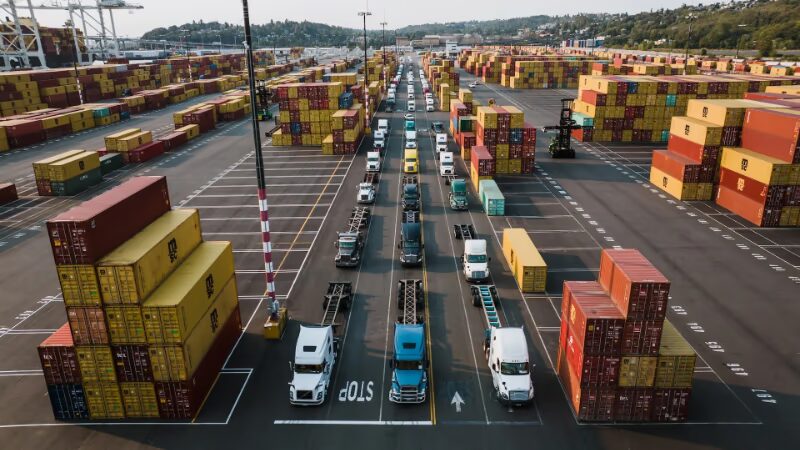 Top view of a container terminal with trucks lined up, waiting to be loaded - Thumbnail